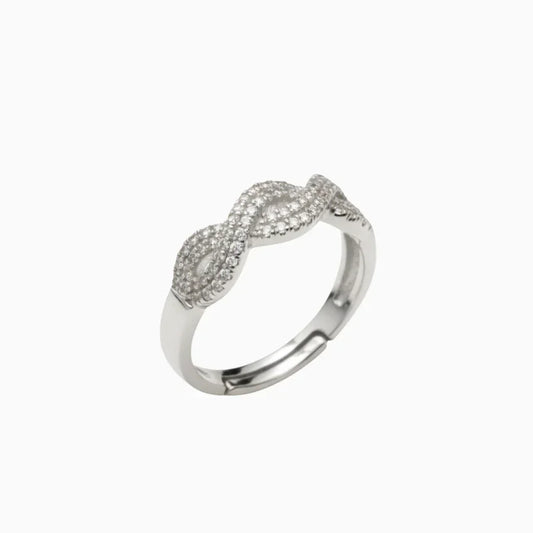 Silver ring with diamond accents on a white background